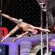 Ashley Fox at 2015 Arnold Classic Pole Championship Series (courtesy of Ashley Fox); badge illustration by Chelsea Beck/GMG